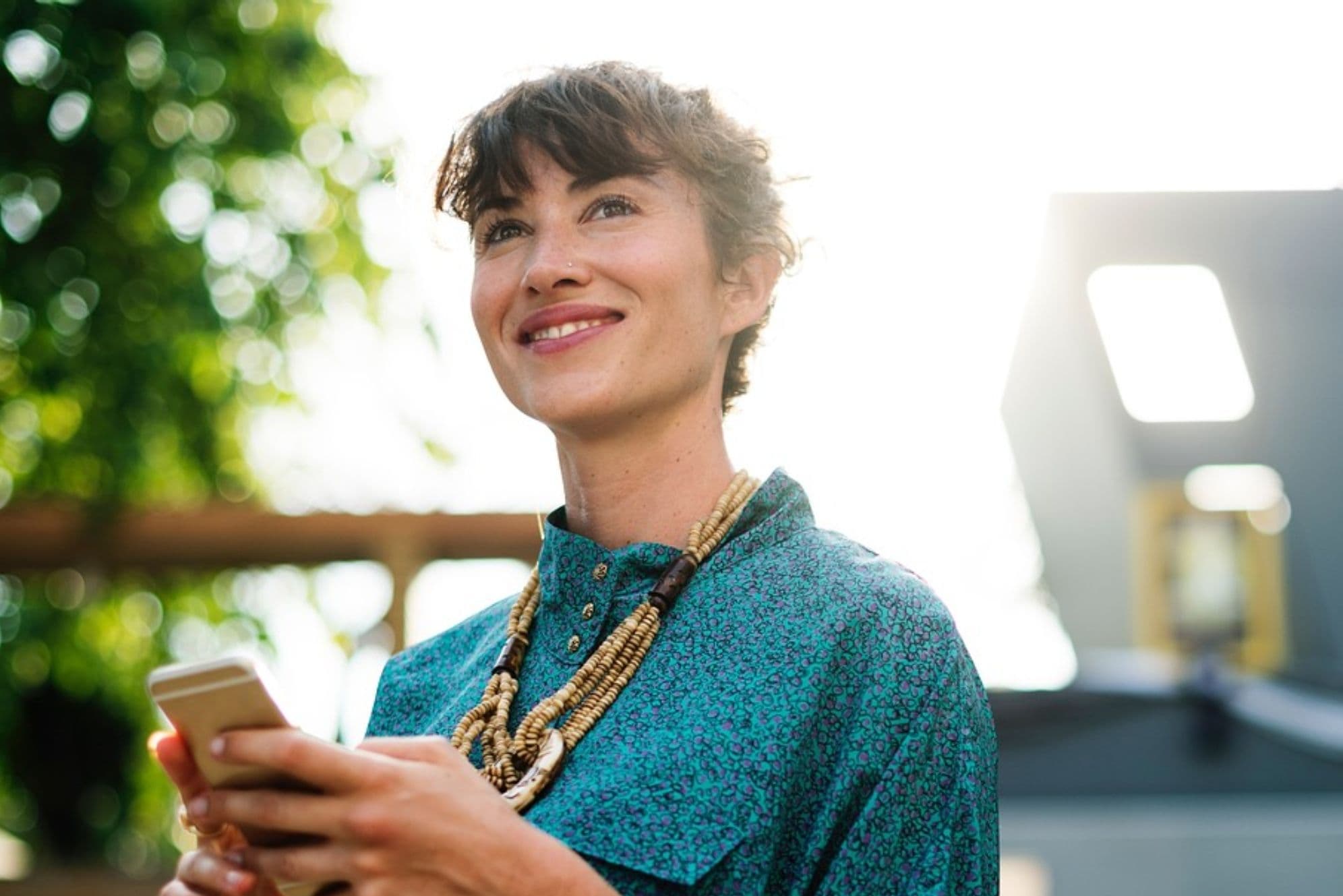 Lady smiling holding mobile phone