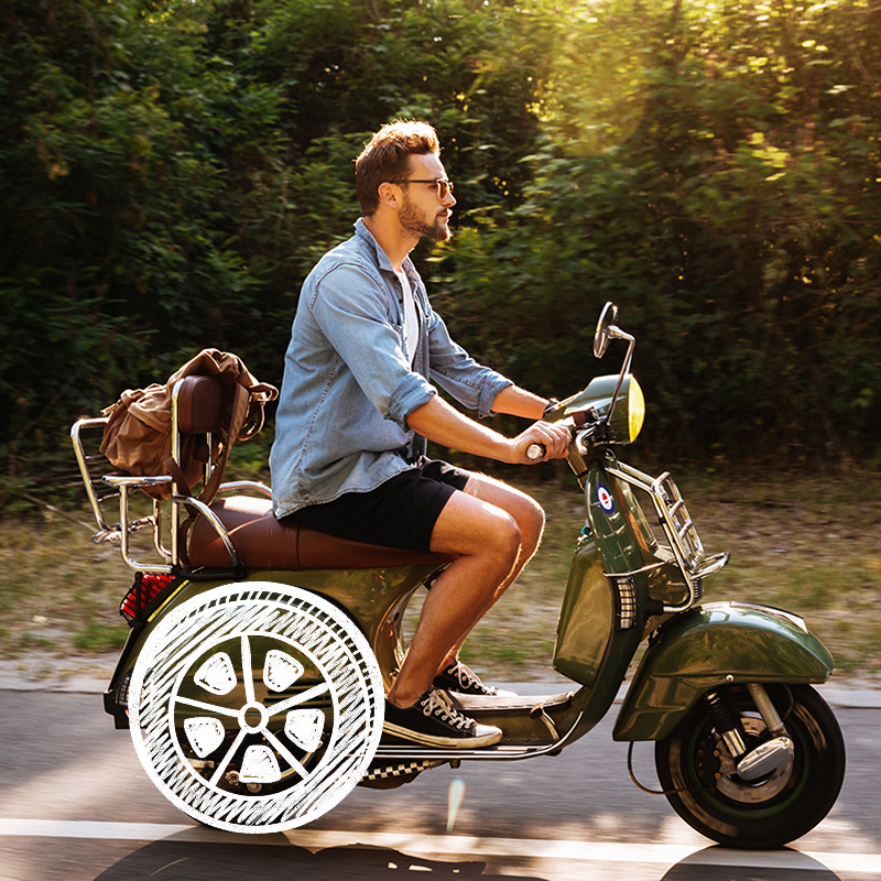 A young man driving vintage motorbike