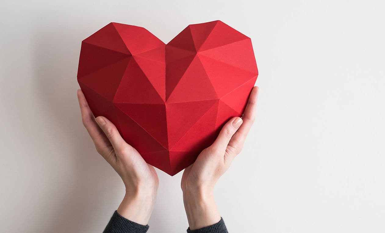 Paper heart in hands