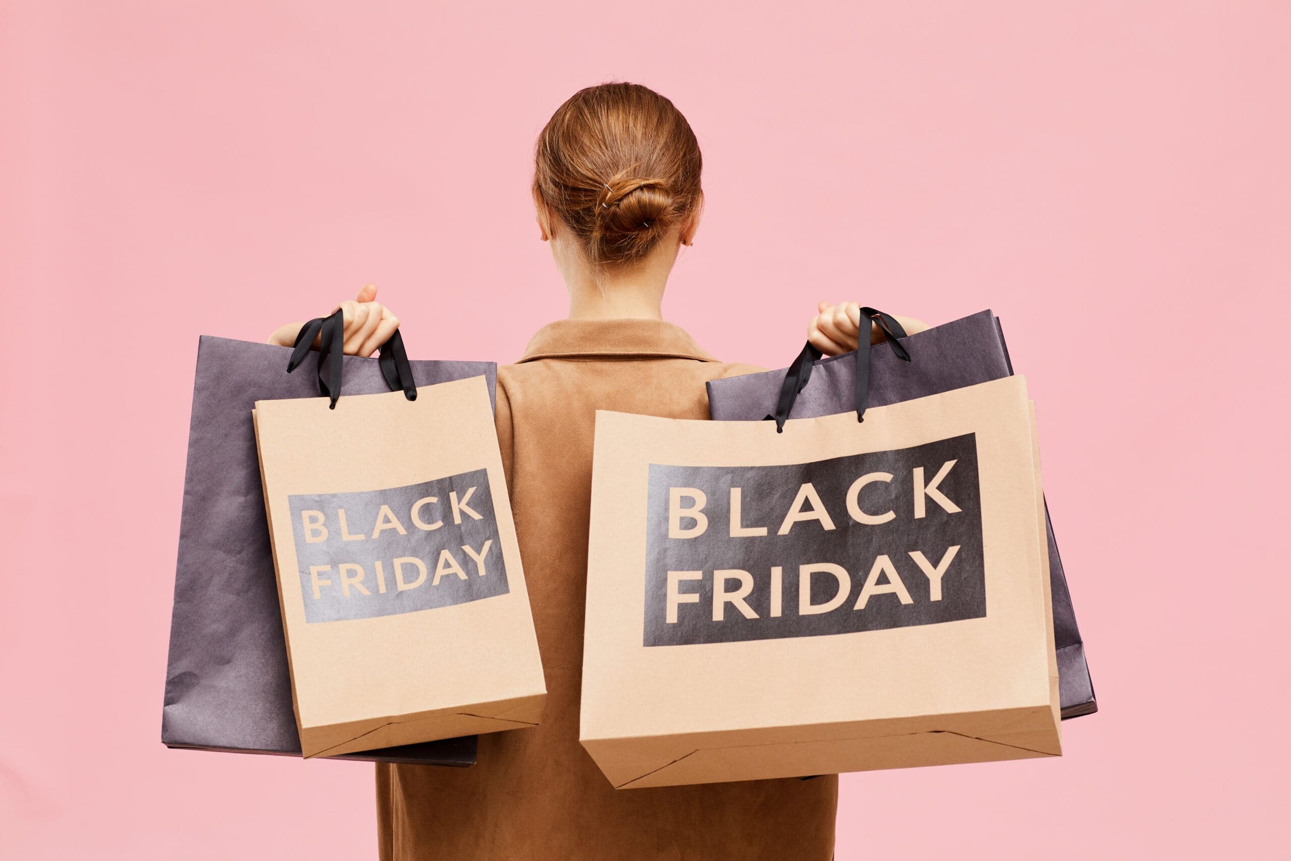 Lady holding 'Black Friday' bags over her shoulders