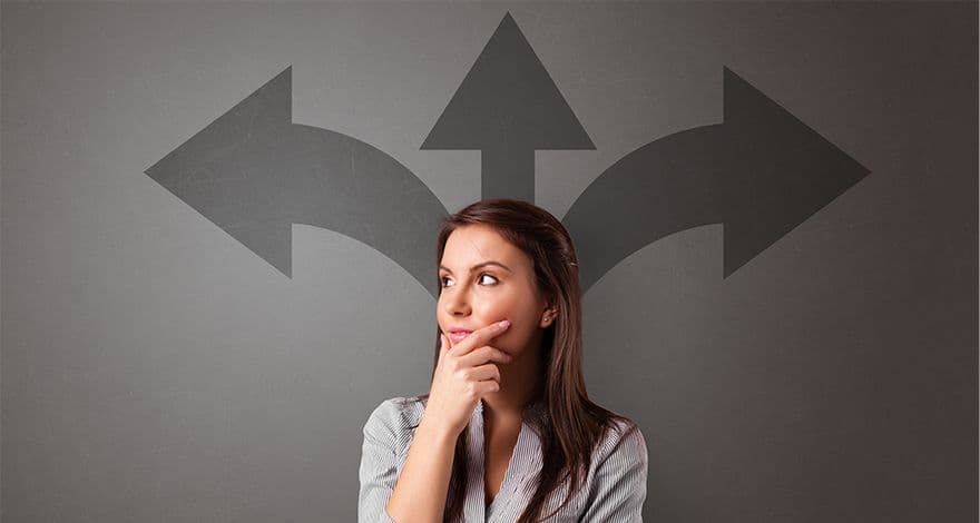 Young woman thinking, with arrows painted in the background, showing three directions (left, straight, right)