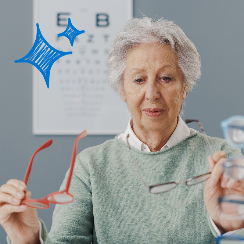 An older woman choosing glasses in ophthalmologist's office