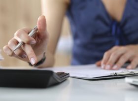 Stressed woman calculating expenses