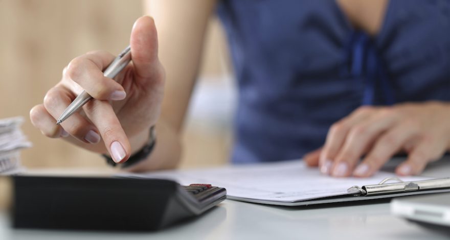 Stressed woman calculating expenses