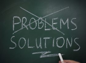 Problem cross out with solutions written on chalk board