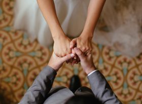 Close up shots of bride and groom holding hands