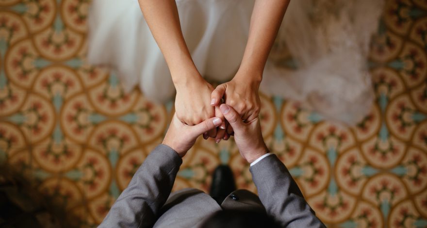 Close up shots of bride and groom holding hands