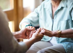 Elderly holding hands