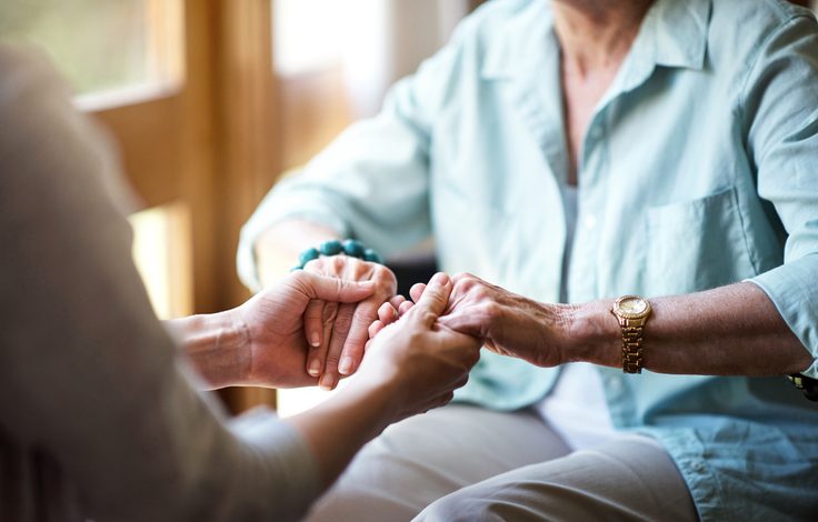 Elderly holding hands