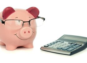 Piggy bank with calculator on the table