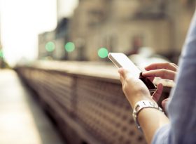 Person holding a phone while walking