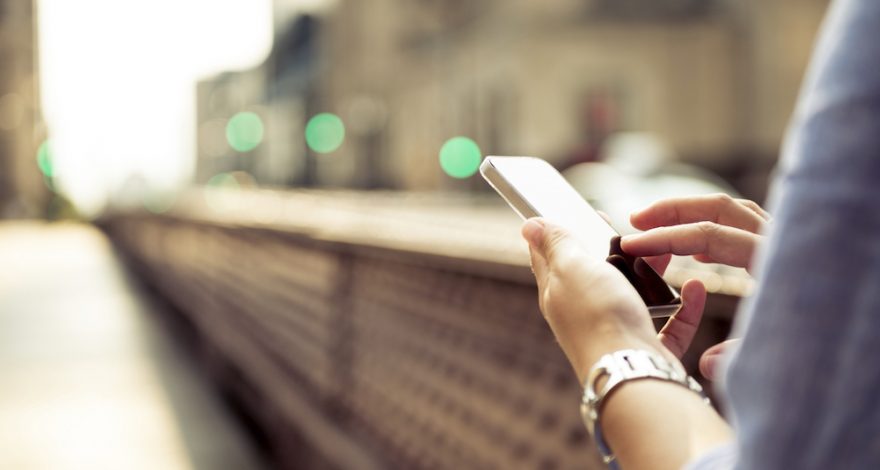 Person holding a phone while walking