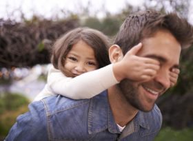 Father giving daughter a piggyback