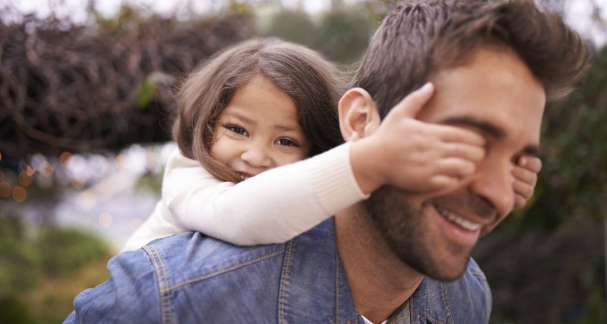 Father giving daughter a piggyback