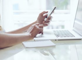 Woman calculating expenses on the mobile phone