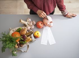 Person putting money into savings in the kitchen