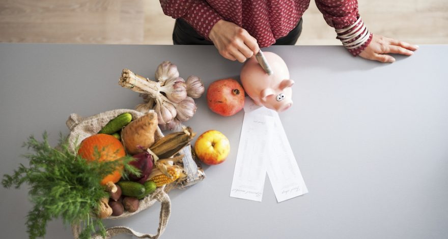 Person putting money into savings in the kitchen