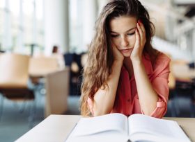 Woman reading a book at café