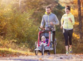 Couple running with pram