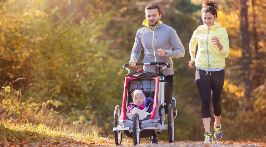 Couple running with pram