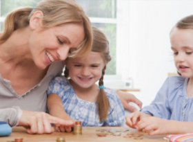Mother with 2 daughters counting coins