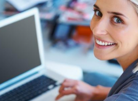 Woman smiling with Mac Book