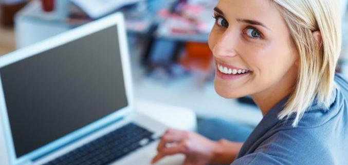 Woman smiling with Mac Book