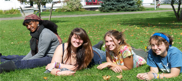 A group of student lying down on grass