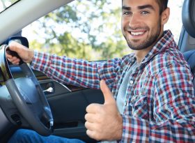 Male Uber Driver with thumbs up in a car