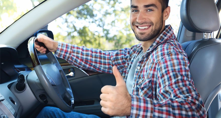 Male Uber Driver with thumbs up in a car